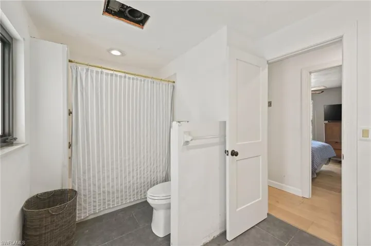 Full bath featuring tile patterned floors and a shower with curtain