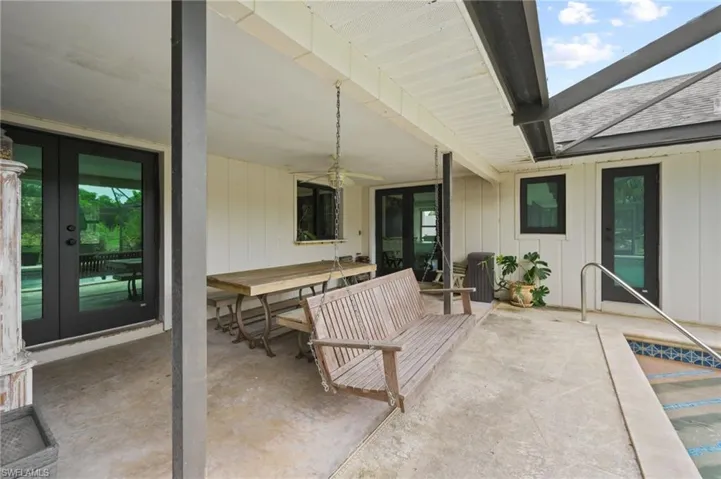View of patio with french doors and a ceiling fan
