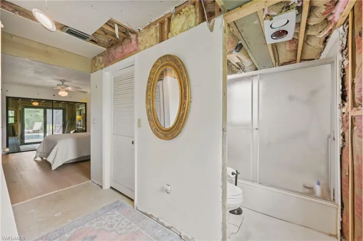 Full bathroom featuring shower / bath combination with glass door and a ceiling fan