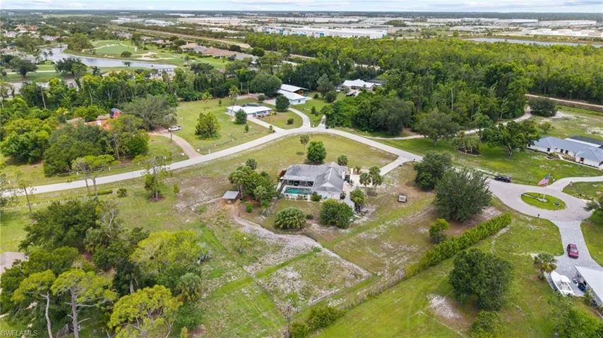 View of property location featuring a nearby body of water and a tree filled landscape