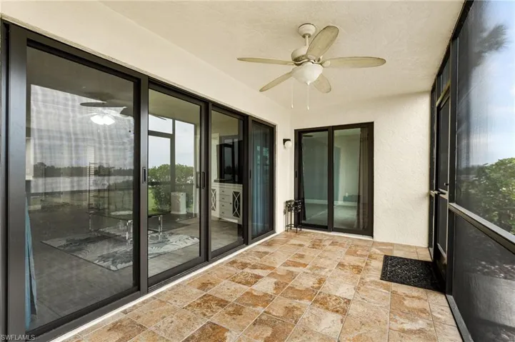 Unfurnished sunroom featuring ceiling fan