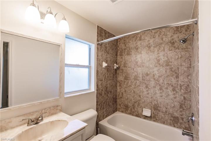 Guest Bathroom with access to lanai & Pool Area