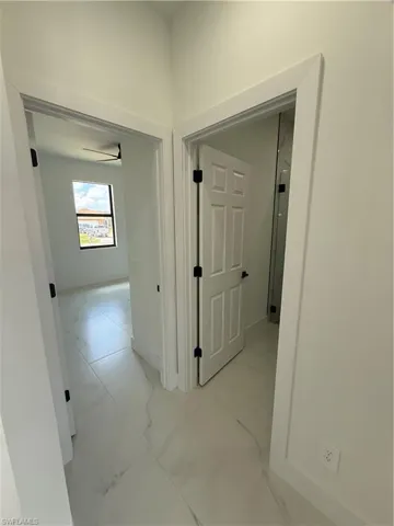 Hall featuring marble finish floor