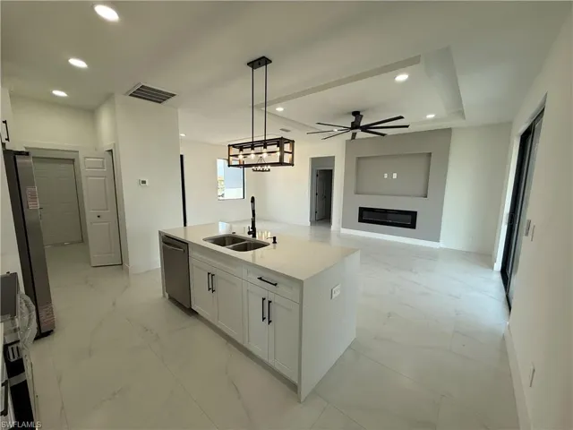 Kitchen featuring stainless steel appliances, recessed lighting, marble finish floor, and a sink