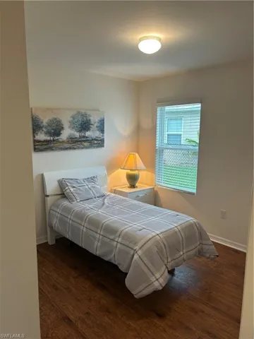 Bedroom with dark wood-style floors