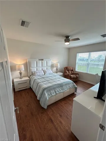 Bedroom featuring dark wood finished floors and a ceiling fan