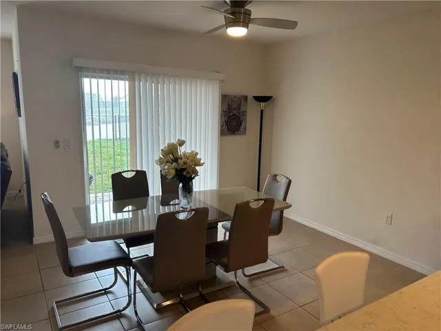 Dining room featuring ceiling fan and light tile patterned floors