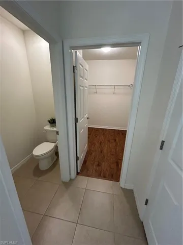 Bathroom featuring a spacious closet and light wood finished floors