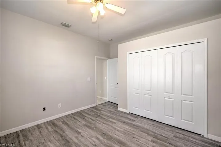 Unfurnished bedroom featuring ceiling fan, a closet, and light hardwood / wood-style floors
