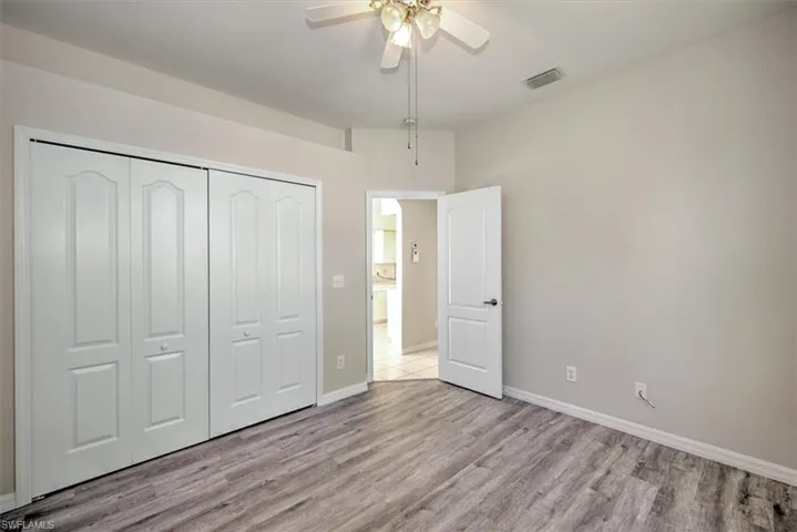 Unfurnished bedroom with ceiling fan, a closet, and light hardwood / wood-style floors