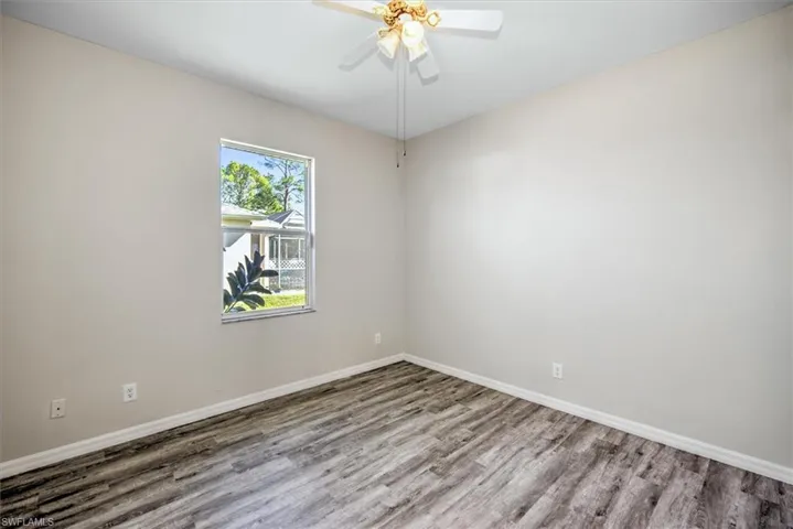 Unfurnished room featuring ceiling fan and wood-type flooring