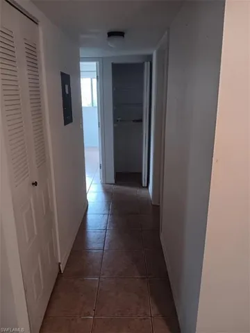 Hall with tile patterned floors and baseboards