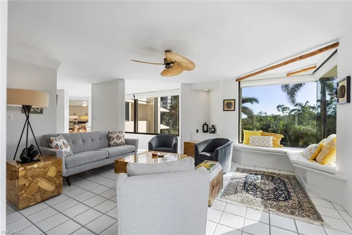 Living room featuring ceiling fan and light tile patterned floors