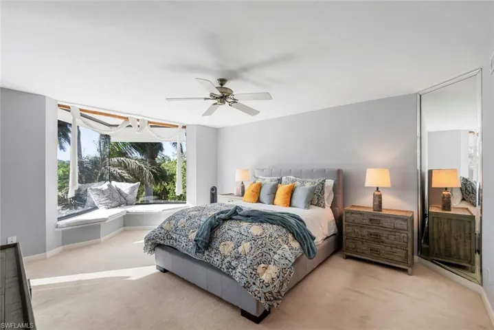 Carpeted bedroom with ceiling fan