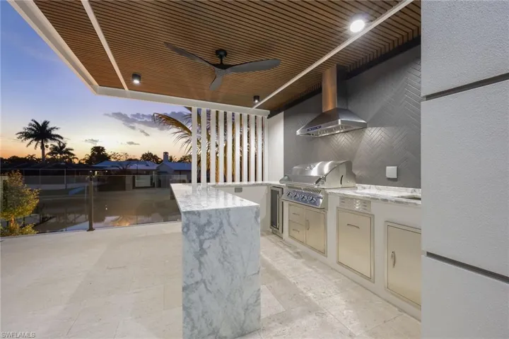View of patio with a ceiling fan and area for grilling