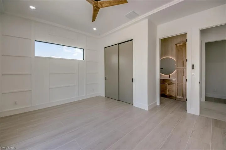 Unfurnished bedroom with wood tiled floors, recessed lighting, ceiling fan, and a closet