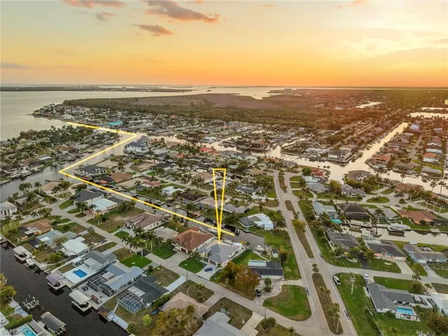 Aerial view of residential area featuring a nearby body of water
