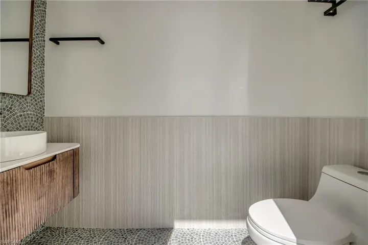 Bathroom featuring a wainscoted wall and vanity