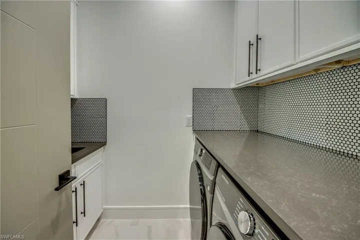 Laundry room featuring cabinet space and separate washer and dryer