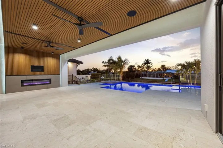 Pool at dusk with a patio area and an outdoor pool