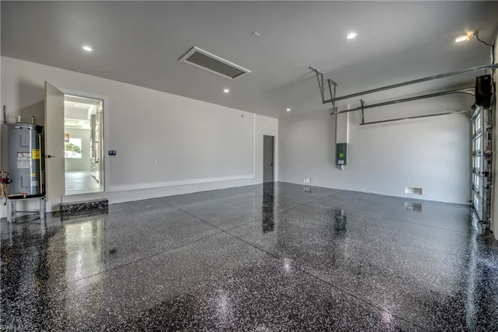 Garage with electric water heater and recessed lighting