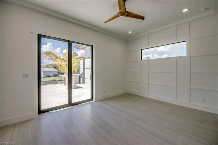 Unfurnished room featuring a ceiling fan, light wood-style flooring, recessed lighting, built in features, and ornamental molding