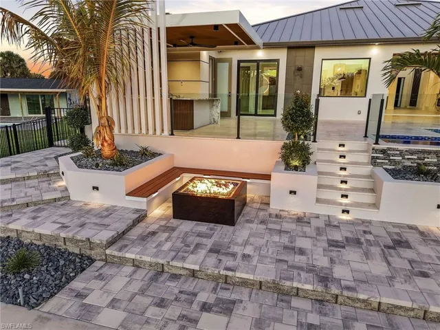 Patio terrace at dusk featuring a patio area and an outdoor fire pit