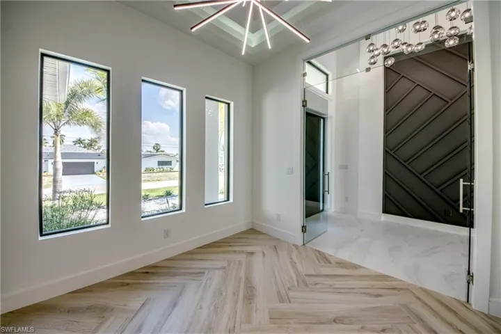 Spare room with baseboards and parquet floors