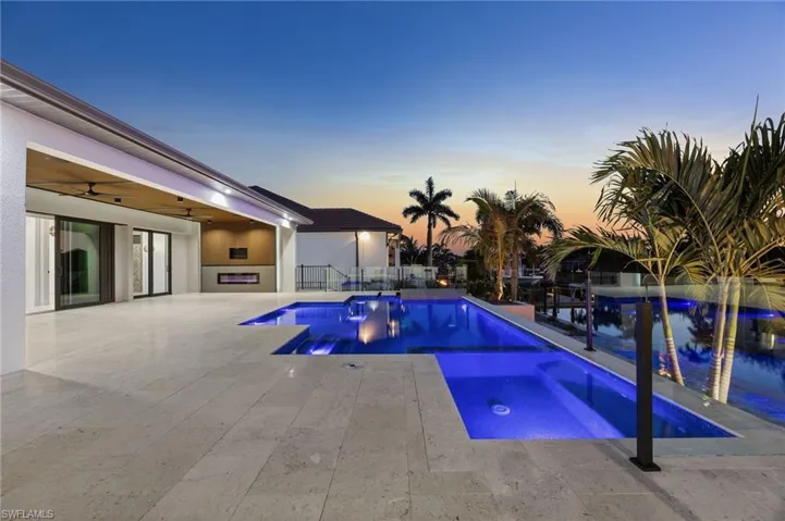 Integrated pool / hot tub featuring a patio area