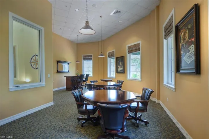 Dining room featuring dark colored carpet and a drop ceiling
