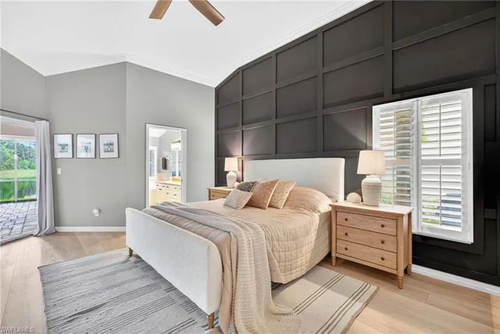 Bedroom with access to outside, light wood-style flooring, crown molding, ceiling fan, and vaulted ceiling