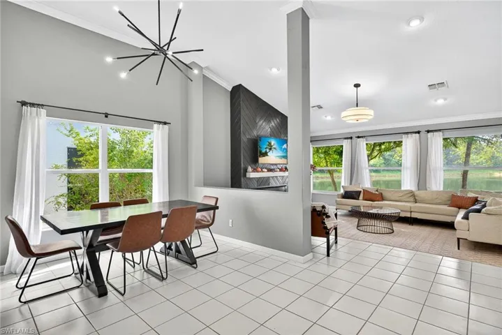 Dining space with crown molding, light tile patterned floors, and recessed lighting
