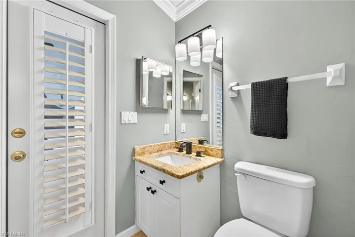 Half bath with vanity and crown molding