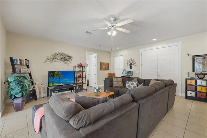 Living room featuring ceiling fan and light tile patterned flooring