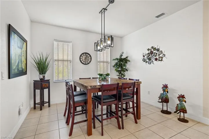 Dining space featuring light tile patterned flooring