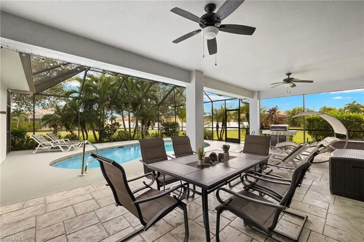 View of patio with glass enclosure and ceiling fan