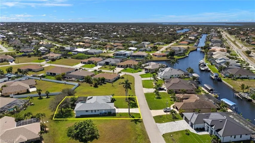 Birds eye view of property with a residential view and a water view