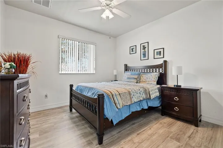 Bedroom featuring ceiling fan and light hardwood / wood-style floors