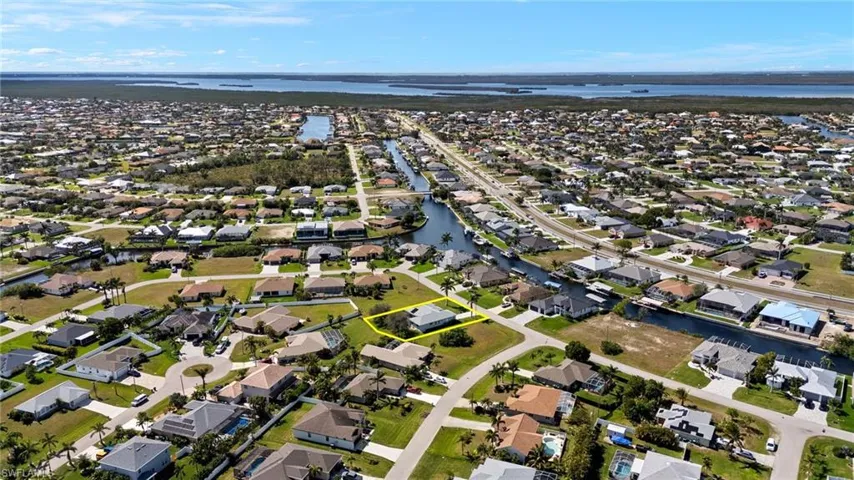 Birds eye view of property with a water view and a residential view