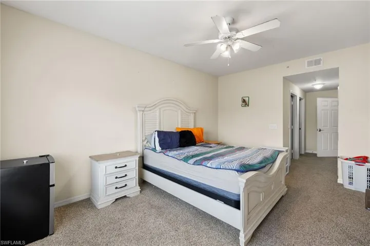 Carpeted bedroom with ceiling fan