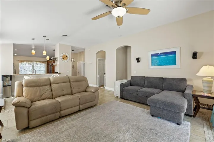 Living room featuring ceiling fan and light tile patterned floors