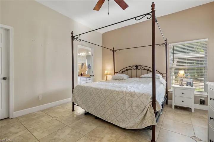 Bedroom with ceiling fan and light tile patterned flooring