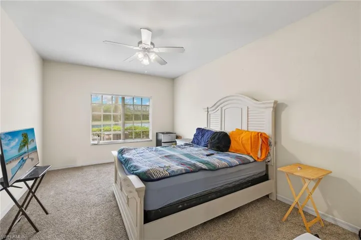 Carpeted bedroom with ceiling fan
