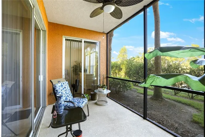Sunroom with a textured wall and a textured ceiling
