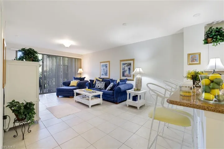 Living area featuring light tile patterned floors and baseboards