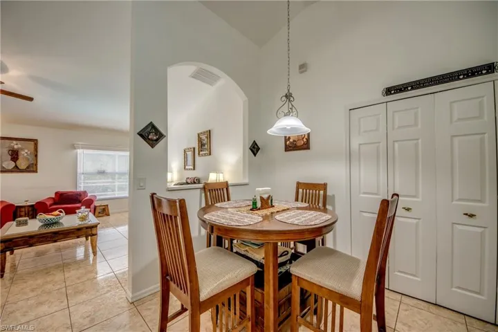 Dining space featuring light tile patterned floors and a ceiling fan
