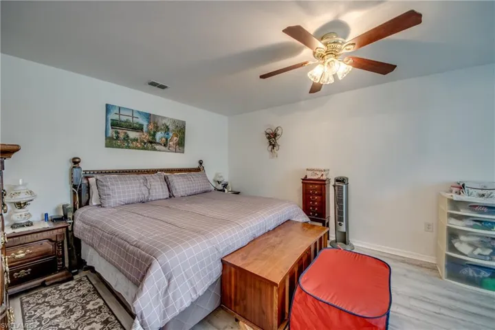 Bedroom with wood finished floors and ceiling fan