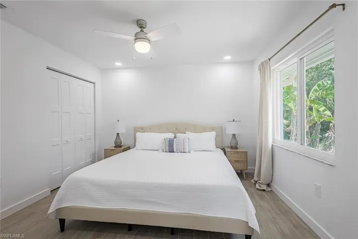 Bedroom featuring light wood-type flooring, recessed lighting, a ceiling fan, and a closet
