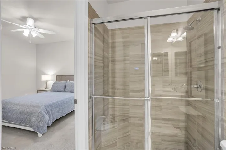 Bathroom with walk in shower and ceiling fan
