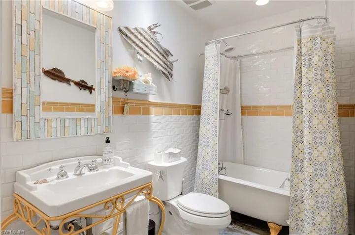 Custom Tile, Clawfoot Bathtub, Pedestal Sink and Skylight